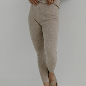 Bare Knitwear Marin Rib Tight - person wearing wheat colored tights on a neutral background