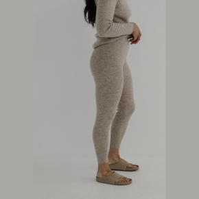 Bare Knitwear Marin Rib Tight - person wearing wheat colored tights on a neutral background
