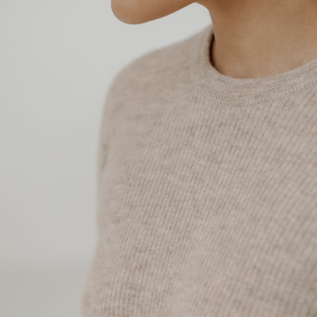 Bare Knitwear Marin Rib Top - person wearing wheat colored long sleeved top on a neutral background