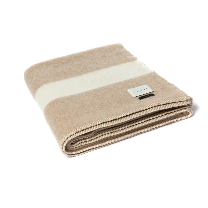 Blacksaw Siempre Recycled Blanket - Beige with Ivory Stripe, a beige blanket with a white stripe folded on a white background.