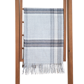A multicolored plaid baby alpaca shawl displayed on a wooden hanger, with a variety of colors including blue, red, orange, and purple.