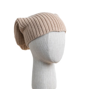 An oversized beige knit alpaca hat displayed on a mannequin head against a white background.