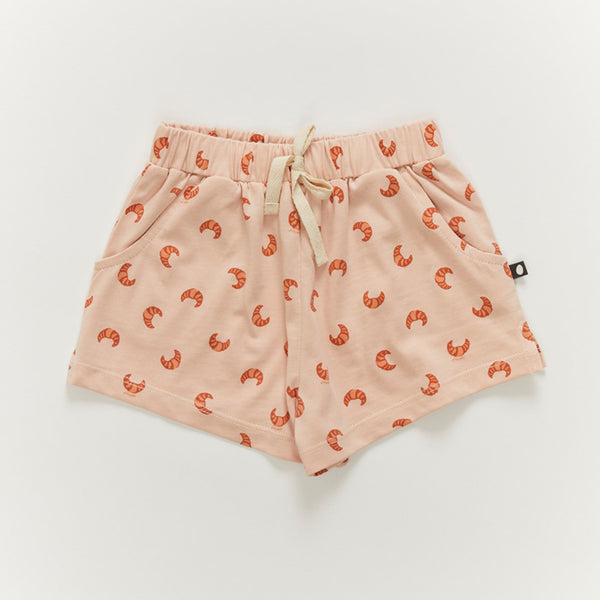 Oeuf Kid's Play Shorts - 100% GOTS Pima Cotton, a pair of pink shorts with croissant print on a white background.