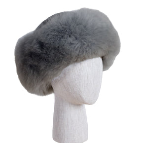 Gray fur hat on a mannequin head against a white background