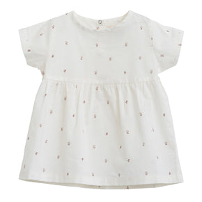 Serendipity Baby Flair Dress - 100% GOTS Certified Cotton for Summer, a white baby flair dress with reddish flowers on a white background.