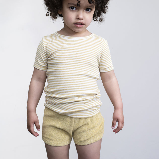 Serendipity Kid's Terry Shorts - 100% Organic Cotton, a child wearing a striped short sleeve top with tan terry shorts on a white background