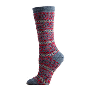 A pair of patterned Tey-Art Alhambra Alpaca socks displayed on a mannequin, showing a geometric design in red and blue colors.