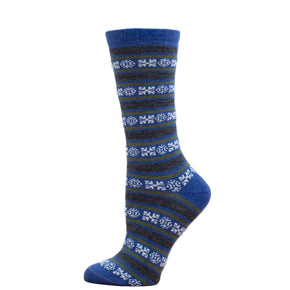 A pair of blue and black striped alpaca socks with geometric snowflake patterns, displayed on a wooden crate.