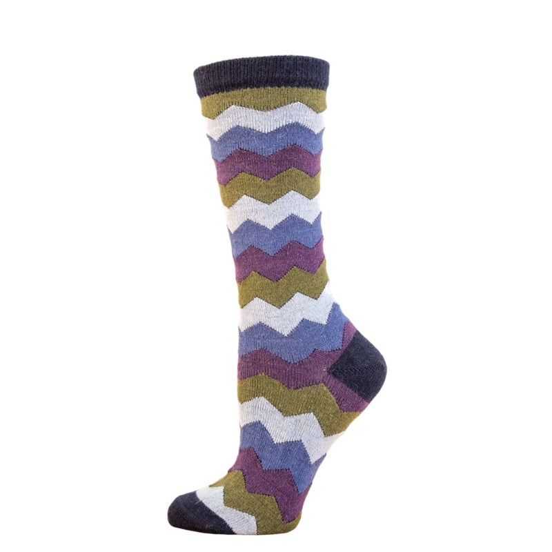 Colorful zigzag patterned sock on a wooden block with a white background