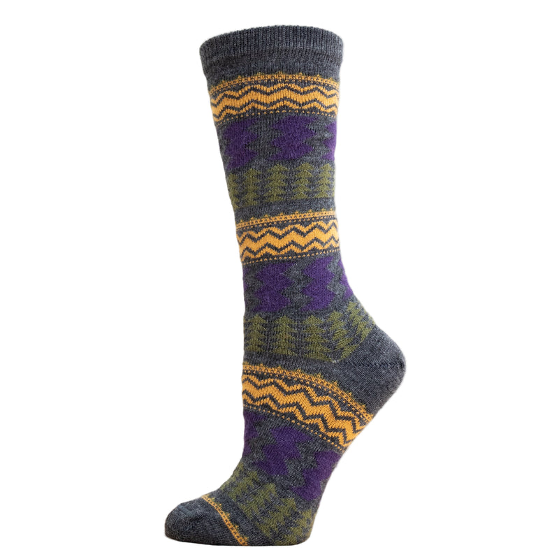 A pair of alpaca striped socks with a geometric pattern displayed on a wooden surface.