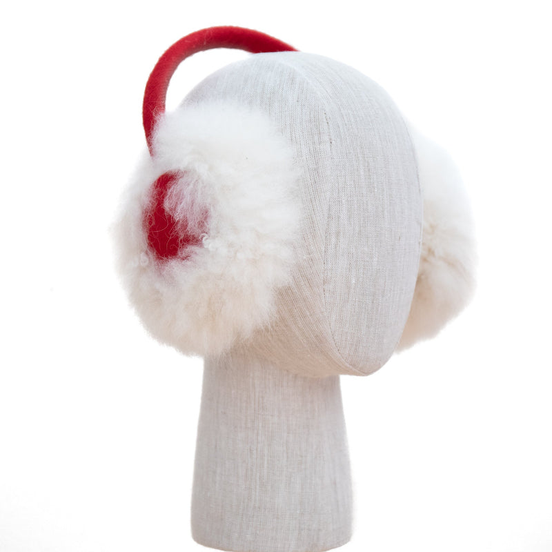 White earmuffs with red interior and white fur ear muffs on a mannequin head against a white background.
