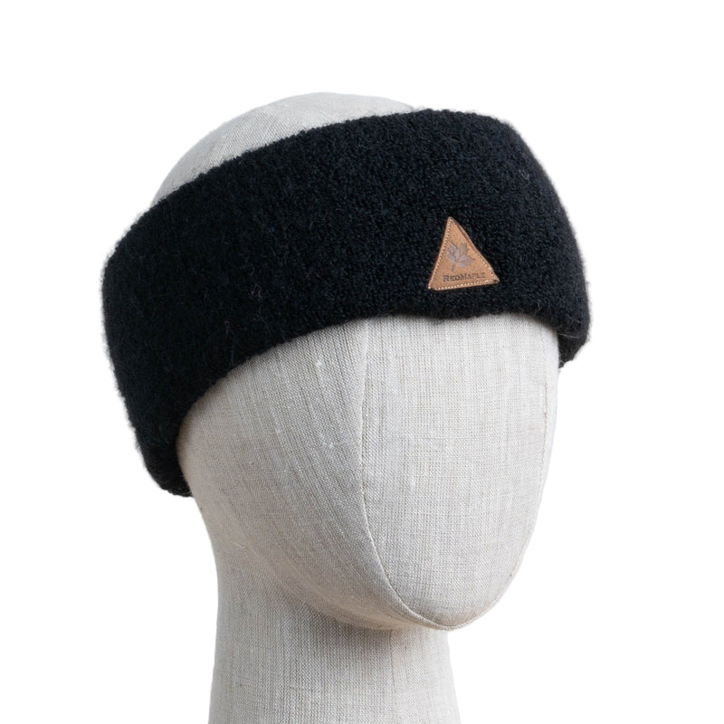 A black alpaca ski headband on a mannequin head.