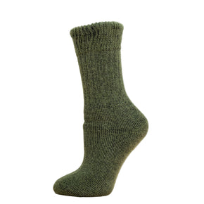 Andinista Alpaca Hiking Socks, a picture of a foot wearing a pair of green alpaca hiking socks on a wooden crate. 