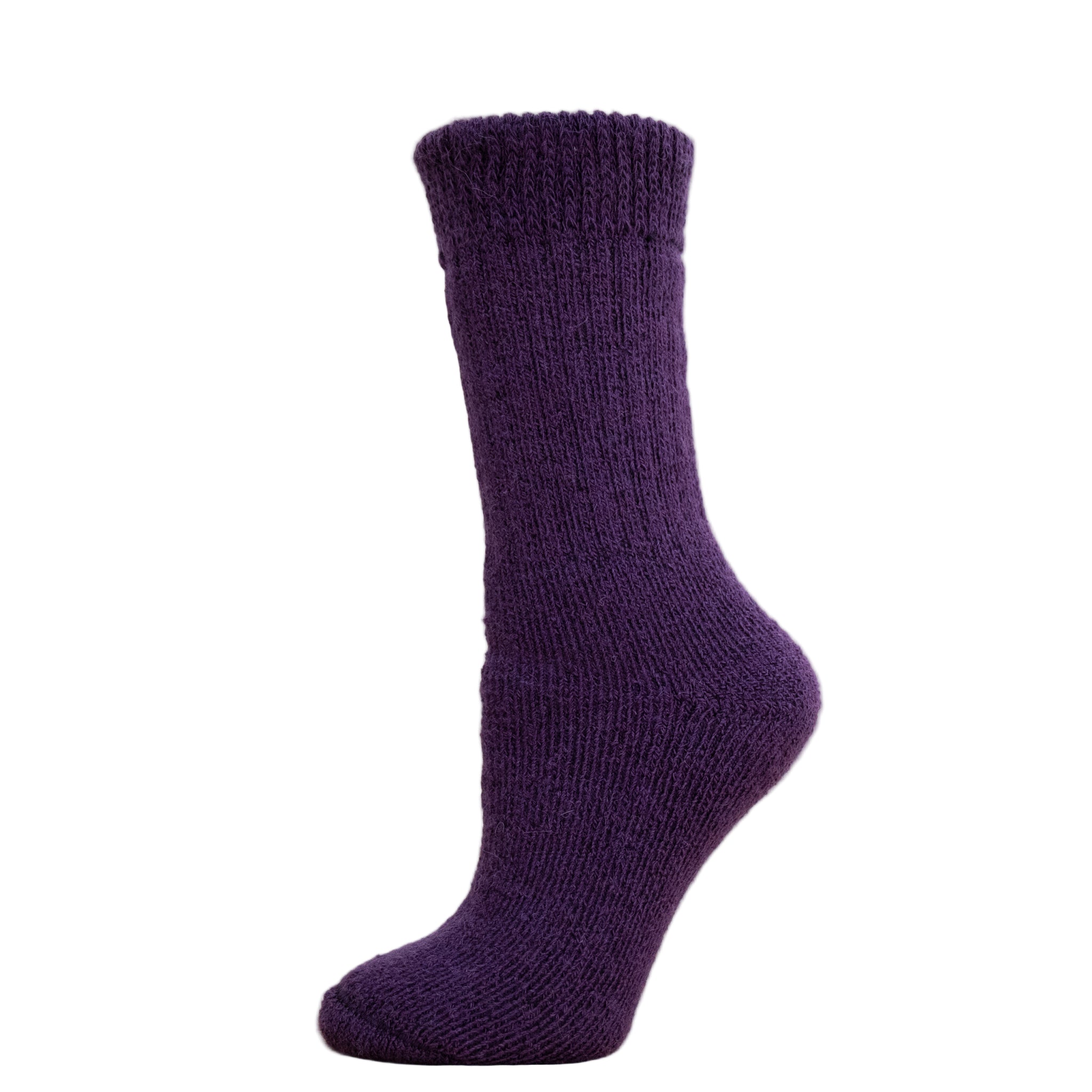 Andinista Alpaca Hiking Socks, a picture of a foot wearing a pair of purple alpaca hiking socks on a wooden crate. 