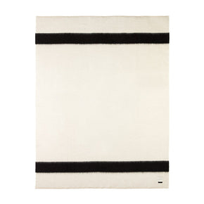 A rolled hem blanket with antique white blanket stitching and black horizontal stripes.