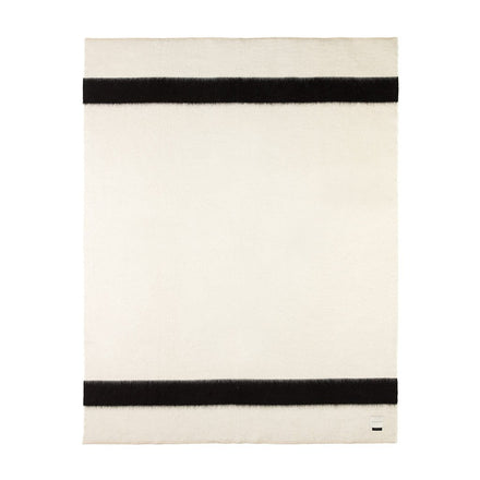 A rolled hem blanket with antique white blanket stitching and black horizontal stripes.