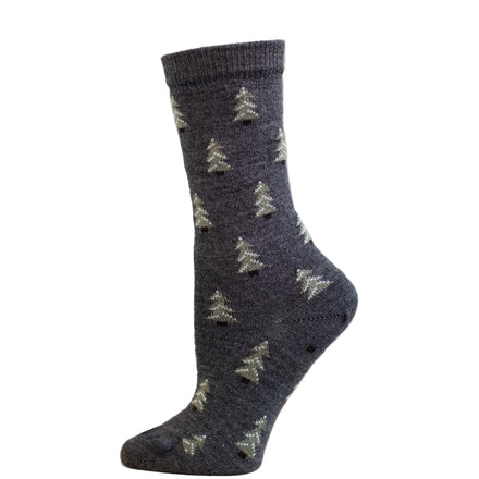 A pair of gray alpaca socks with a pine tree pattern displayed against a wooden backdrop.