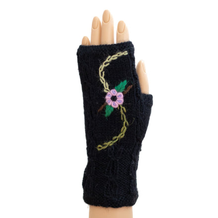 A pair of black alpaca fingerless gloves with embroidered floral designs on the back of the hand.