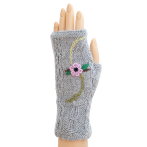Gray knitted fingerless glove with floral design on a white background