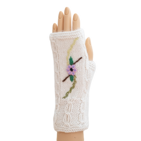 Knitted fingerless glove with floral design on a white background
