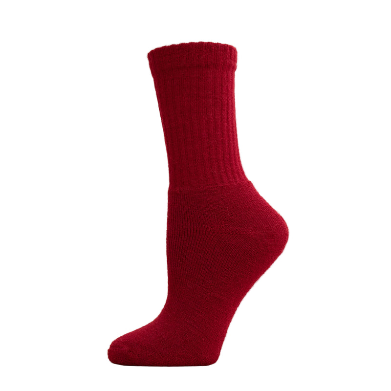 A red alpaca crew sock displayed on a mannequin foot.