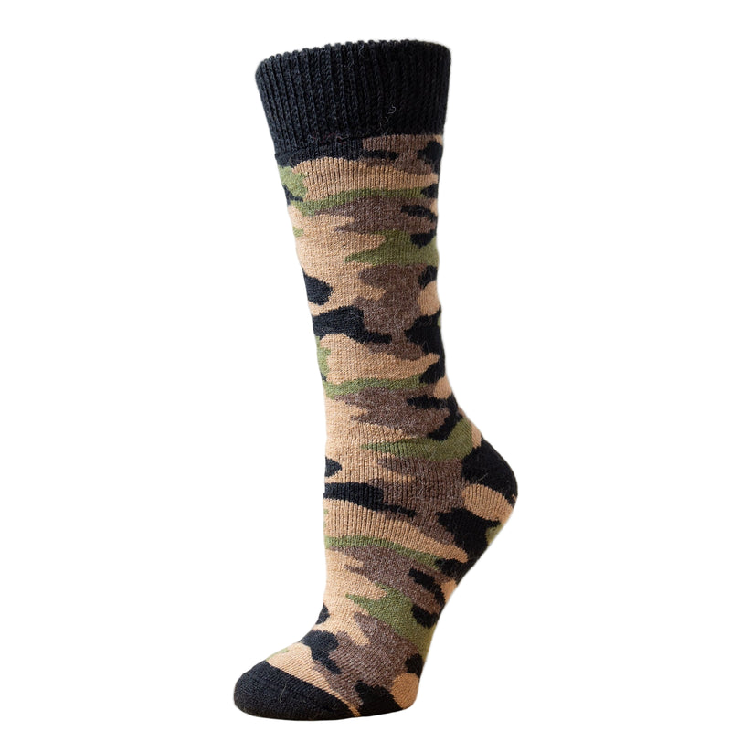 A camouflage patterned alpaca sport sock, with the top edge in black, displayed against a wooden backdrop.