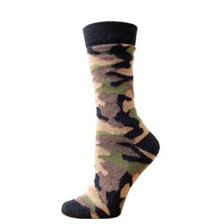 A camouflage patterned crew sock on a mannequin's foot against a wooden background.