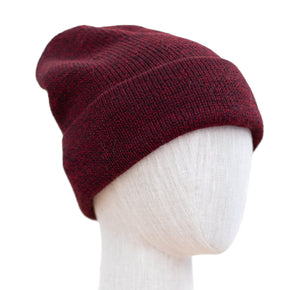 A red Molinet Baby Alpaca hat displayed on a mannequin head.