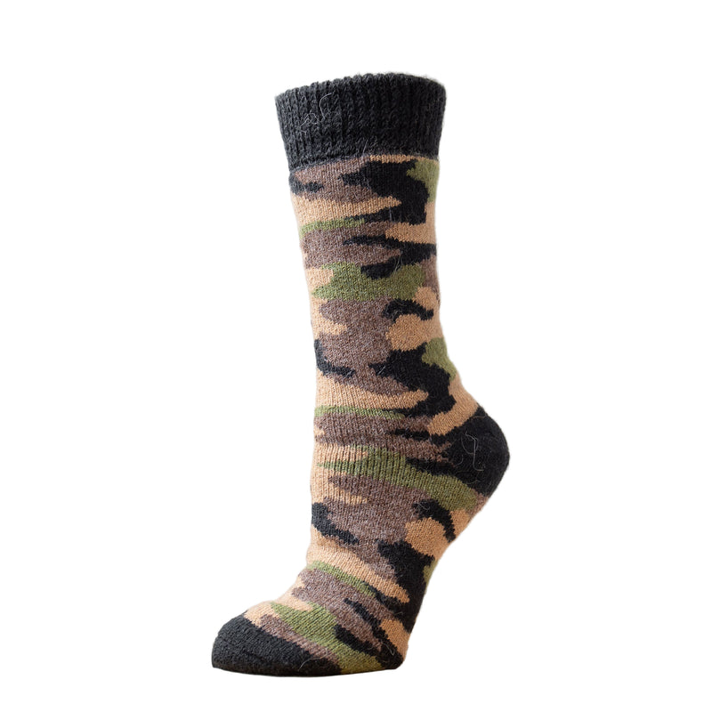 A camouflage patterned alpaca wool sock displayed on a stand, with the toe visible and the heel turned away from the camera.