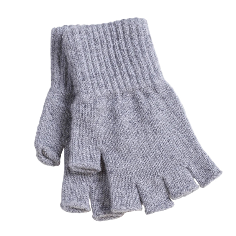 A pair of gray fingerless alpaca wool gloves laid flat on a wooden surface.