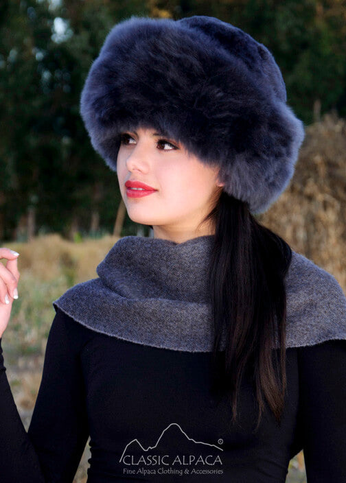 Premium Baby Alpaca Fur Hat. A woman wearing a charcoalPremium Baby Alpaca Fur Hat against a forest background.