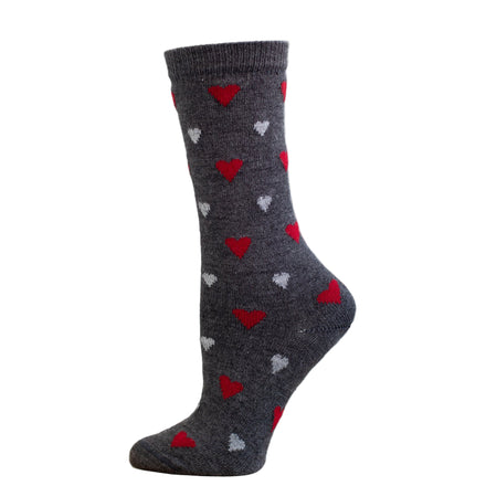 A heart patterned alpaca sock in front of a white background