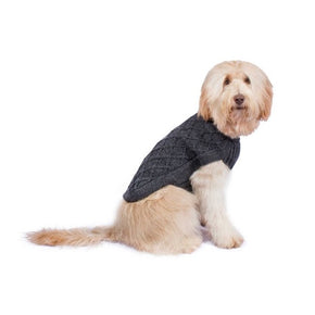 Dog wearing a grey cable knit dog sweater on a white background