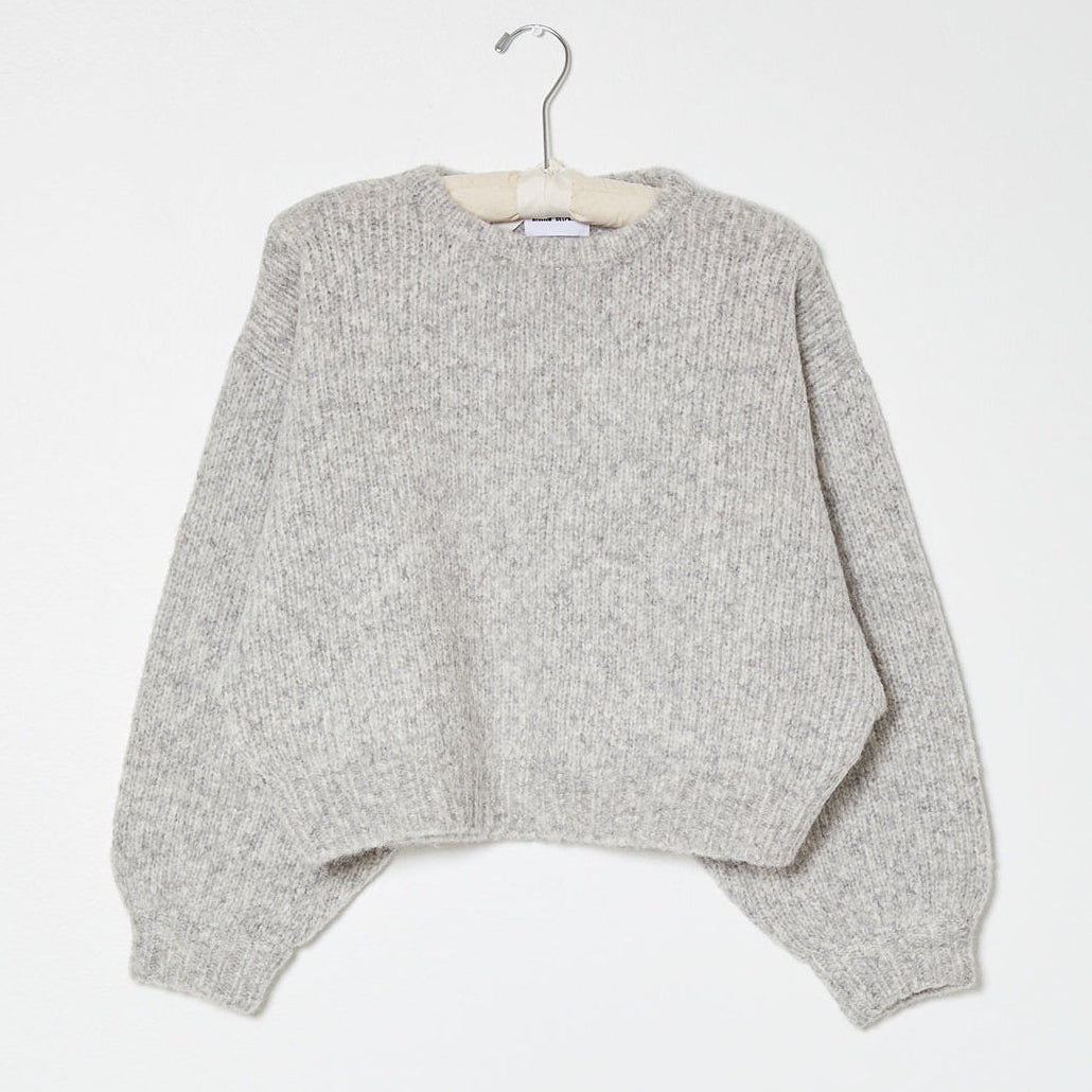 Light grey knit sweater on white background