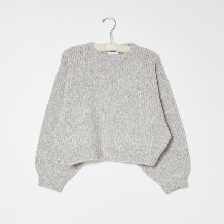 Light grey knit sweater on white background