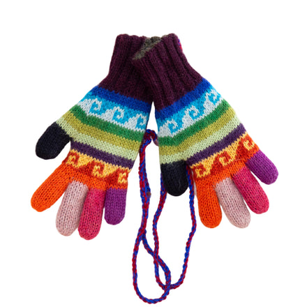 A pair of multicolor baby alpaca gloves with geometric patterns, laid flat on a white wooden surface.