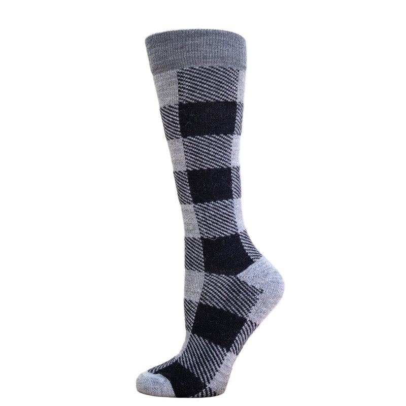 Gray and black checkered sock on a wooden block with a white background
