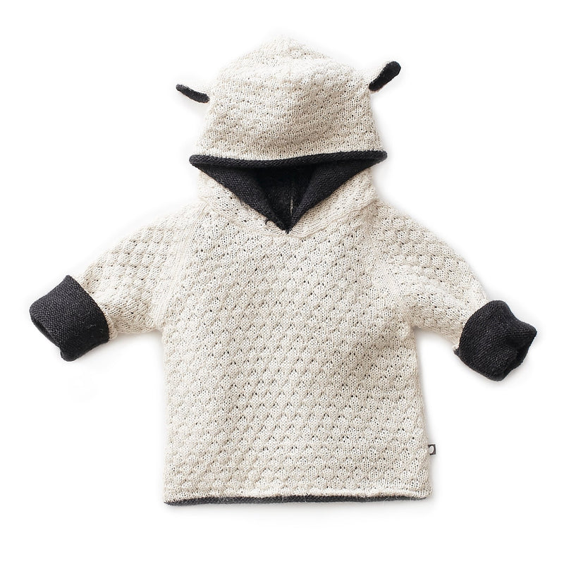 A beige and black hand-knit hoodie for babies with sheep ears on the hood, part of the Oeuf Collection.