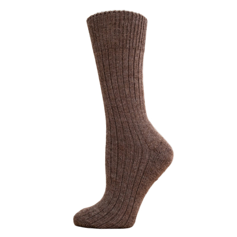 A brown ribbed alpaca wool sock displayed on a wooden platform.