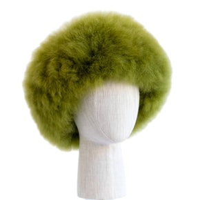 Premium Baby Alpaca Fur Hat. A green Premium Baby Alpaca Fur Hat on a mannequin head against a white paneled background.