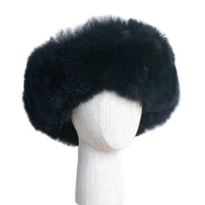 Premium Baby Alpaca Fur Hat. A black Premium Baby Alpaca Fur Hat on a mannequin head against a white paneled background.