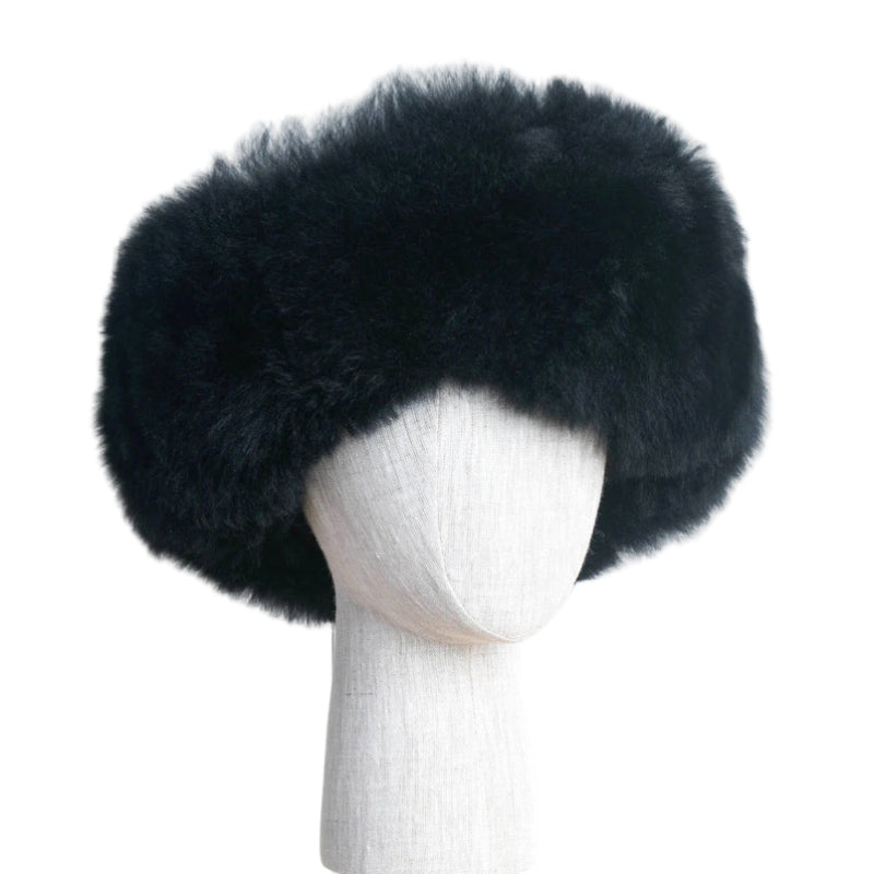 Premium Baby Alpaca Fur Hat. A black Premium Baby Alpaca Fur Hat on a mannequin head against a white paneled background.