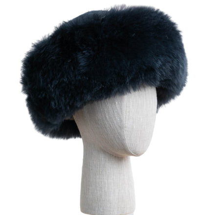 Premium Baby Alpaca Fur Hat. A bluish charcoal Premium Baby Alpaca Fur Hat on a mannequin head against a white paneled background.