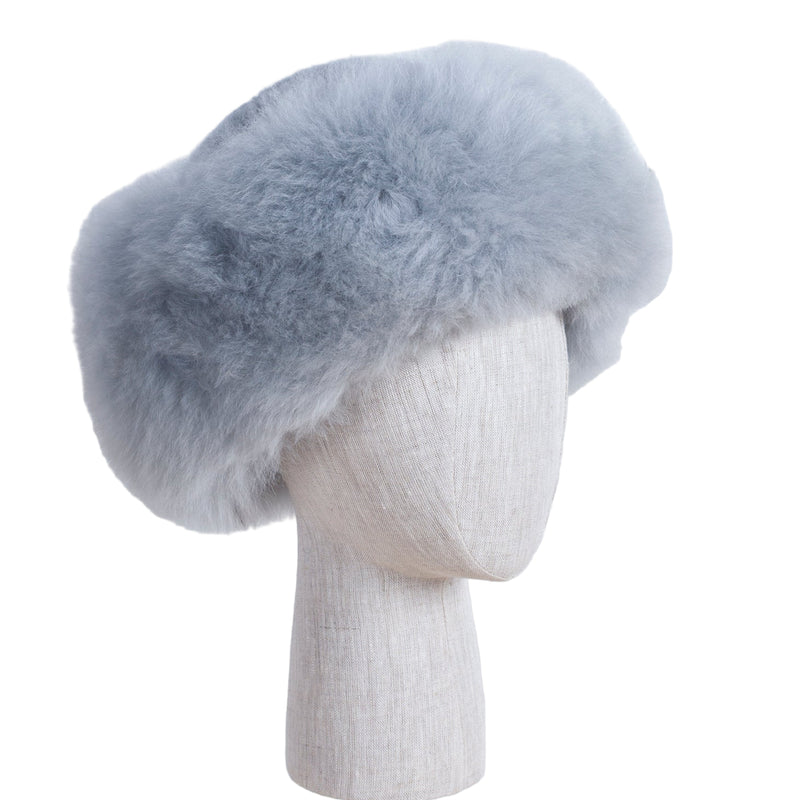 Premium Baby Alpaca Fur Hat. A light grey Premium Baby Alpaca Fur Hat on a mannequin head against a white paneled background.