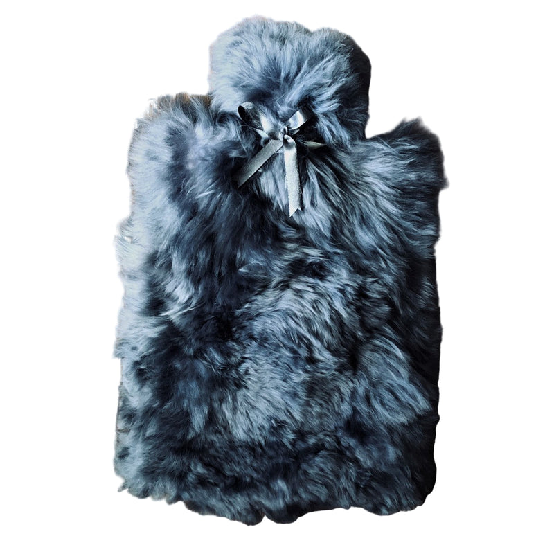 A hot water bottle cover made of alpaca fur and lambskin, predominantly gray in color, with a satin bow on the front.