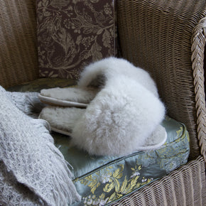 light grey alpaca fur fuzzy slippers on chair