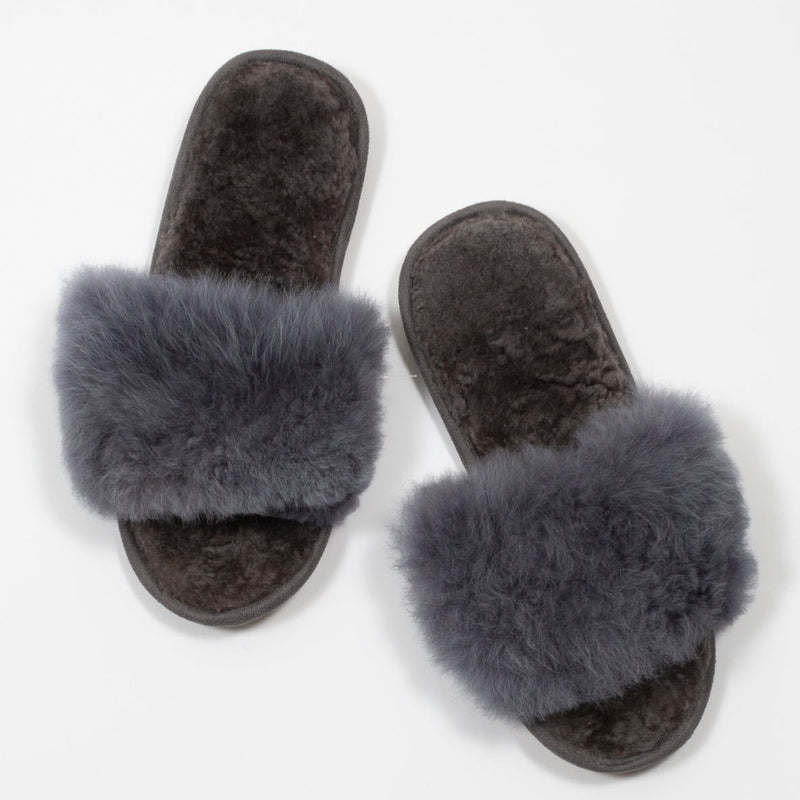 Pair of steel grey fur slippers on a white background