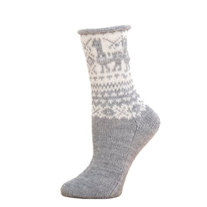 Gray and white patterned sock on a wooden surface with a white background