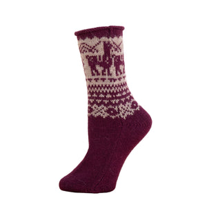 Purple knitted sock with a pattern on a wooden surface