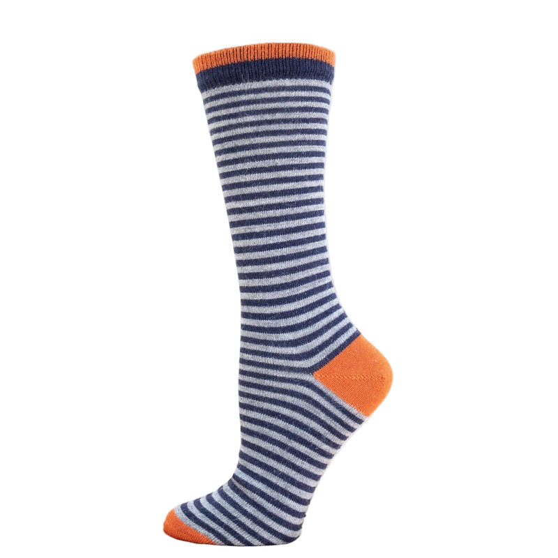 A striped alpaca dress sock with blue and white horizontal stripes and orange accents on the cuff, displayed on a wooden platform.